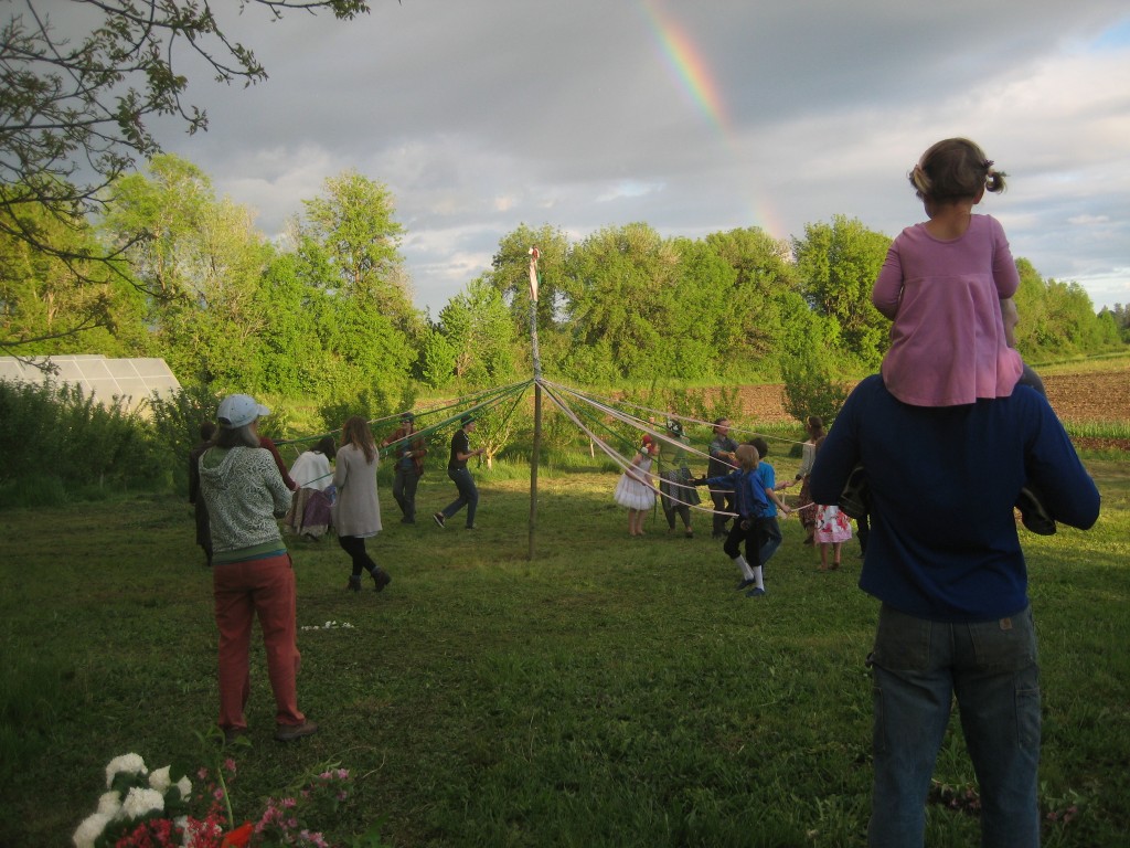 Dottie watches the May pole dance from atop Casey's shoulders.